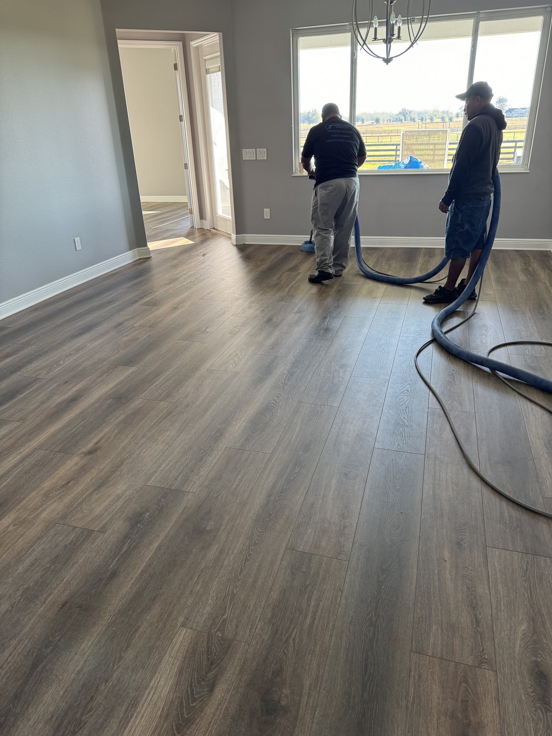 Compton Services crew performing post-construction cleaning in a new Villages home